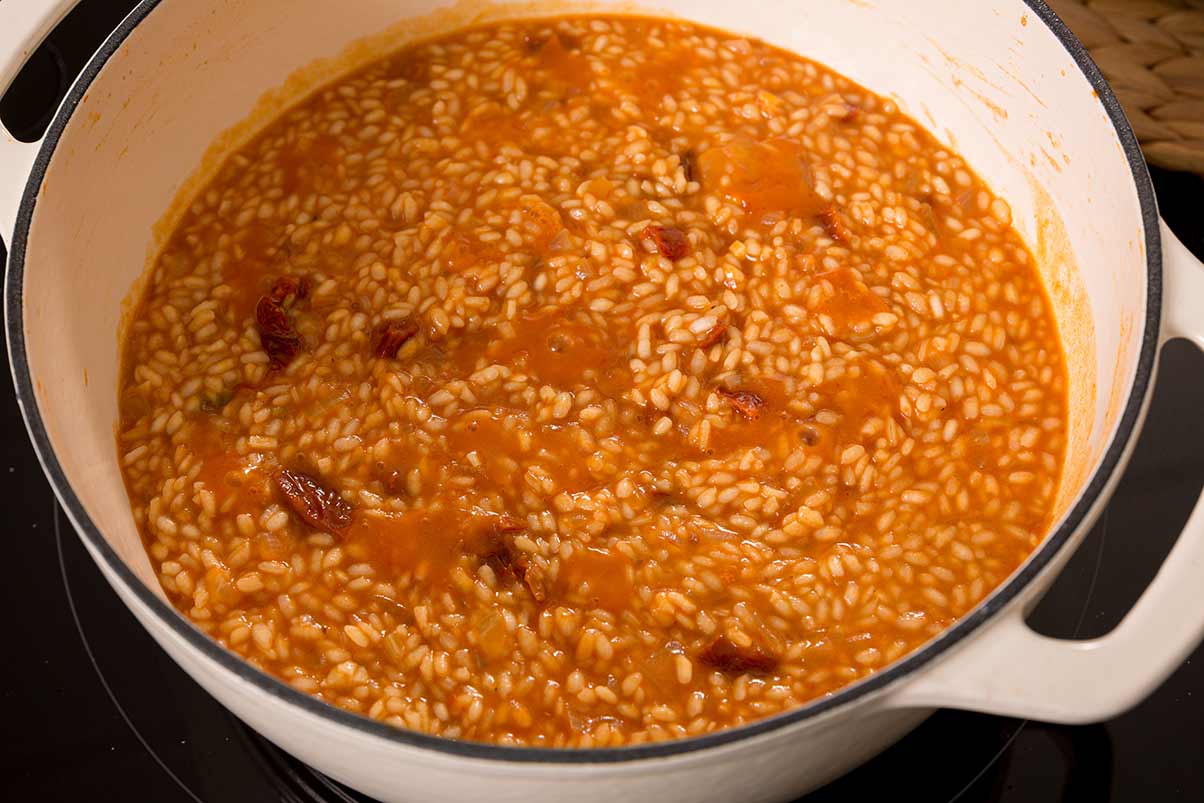 Arroz meloso de tomate y albahaca Paso 4 pasados diez minutos, incorporamos los tomates secos picados y dejamos hervir