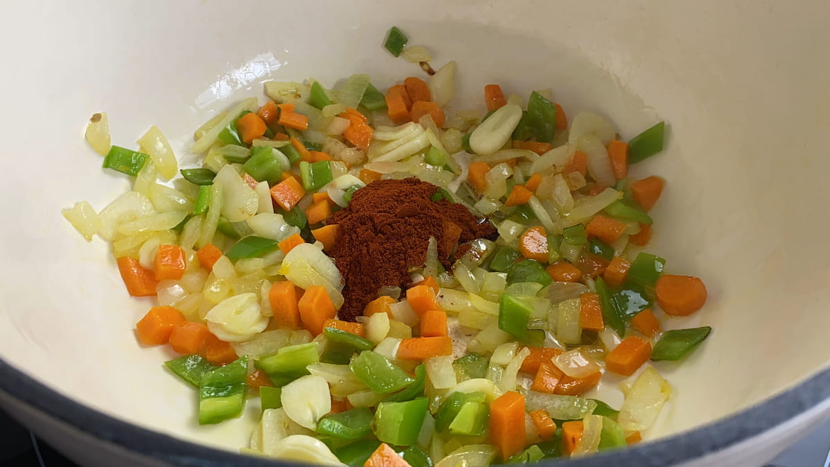 Receta lentejas con arroz paso 3 añadimos el ajo laminado, removemos, agregamos una cucharadita de pimentón dulce