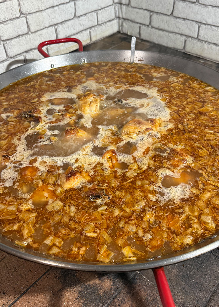 añade el caldo para paella de pollo